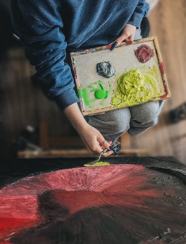 a person holding a painting pallete with paints