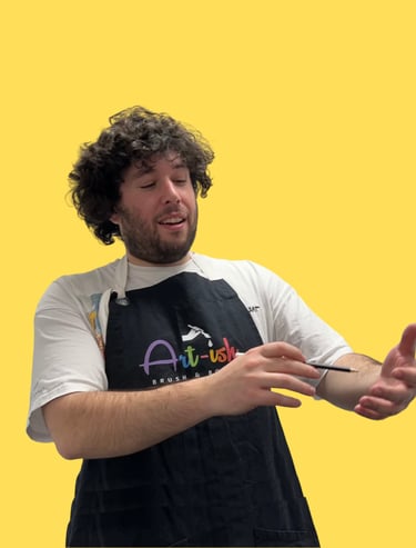 Jordan in a apron holding a paintbrush