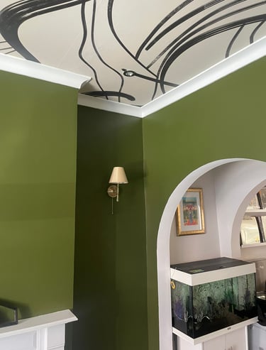 deep green walls, papered ceiling and fish tank