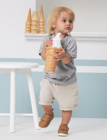 Fashion campaign photography - a toddler holding an ice cream in front of an ice cream shop