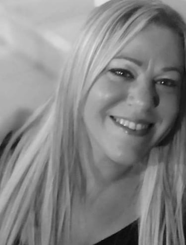 a woman with blonde hair and a black shirt