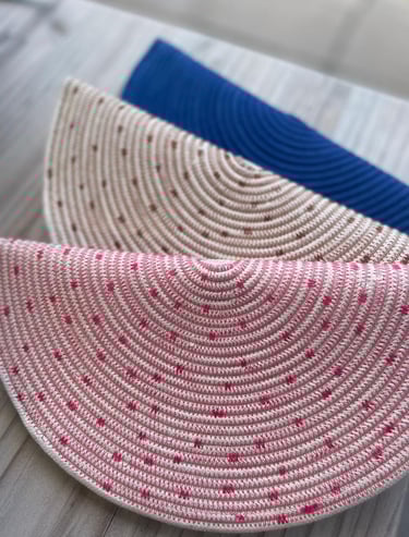 a pair of straw hat with polka dot dots on it
