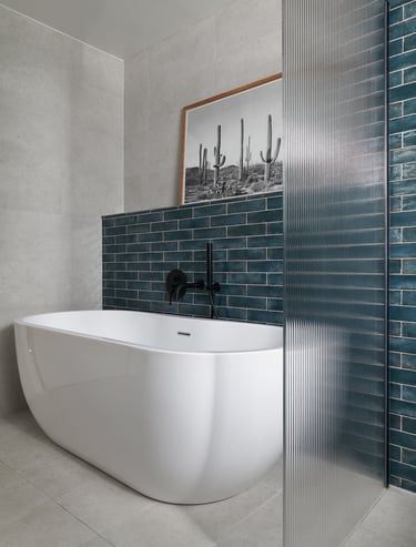 deep, glossy teal metro tiles, laid in a horizontal stack with white grout and fluted shower screen