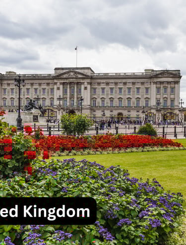 A wide, eye-level view of Buckingham Palace in London, United Kingdom, seen from across the Queen Vi