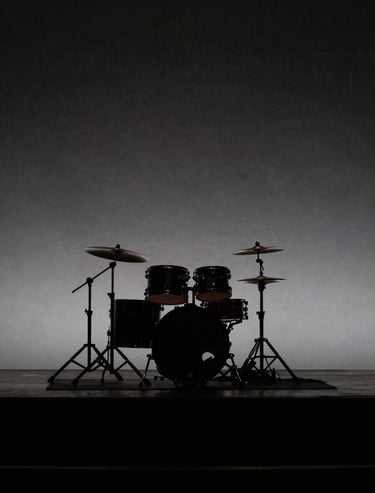 Silhouetted drum kit on an empty stage before a show. Minimalist, elegant, dark aesthetic using deep blacks and subtle gray highlights. Western European / Dutch concert hall.
