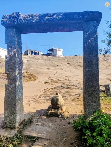 Yoga Nandeeshwara Temple perched at the summit of Nandi Hills, Karnataka, surrounded by rocky terrain and greenery