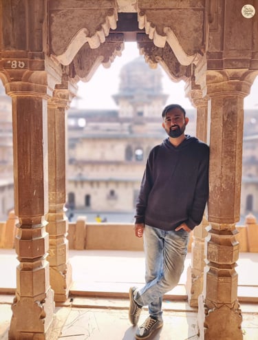 By the arches of Jahangir Mahal's grand courtyard, Orchha