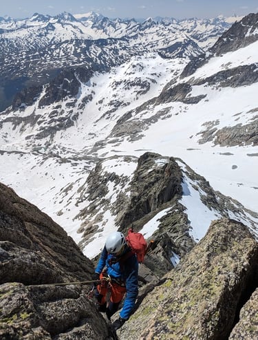 a man climbing a mountain in the alps