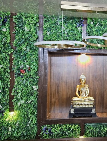a buddha statue in a room with a green wall