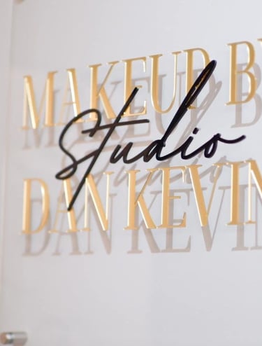 Acrylic Wall Frame with Gold and black text that say Makeup by studio Dan Kevin