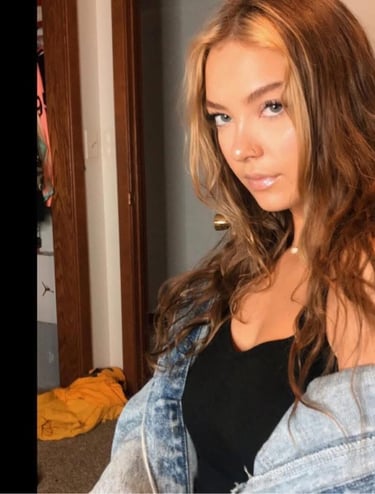 a woman with long hair and a denim jacket