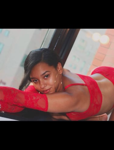 a woman in a red lingersuit posing for a picture