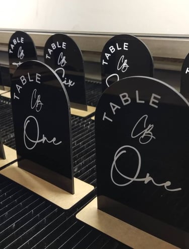 Black Table Numbers oval shaped with text saying Table and the numbers