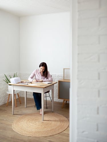a woman sitting at a table with papers