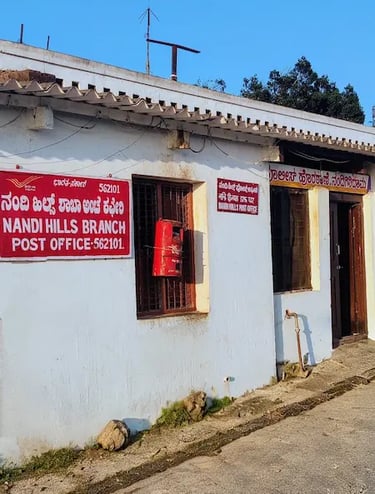 Tiny historic post office at the Nandi Hills summit, reflecting old-world charm amid misty hill surroundings near Bengaluru