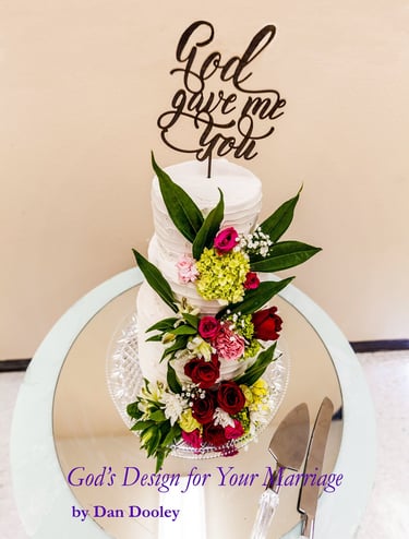 Elegant tiered white wedding cake with fresh red roses and a God Gave Me You topper.