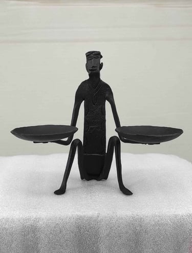"Handcrafted tribal iron art-seated man holding oil lamps-front view-for international trade"