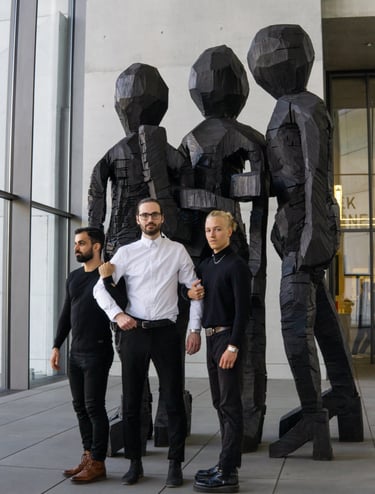 a group of men standing next to a statue of a man