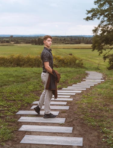 Portrait photo of a young man in a greenery