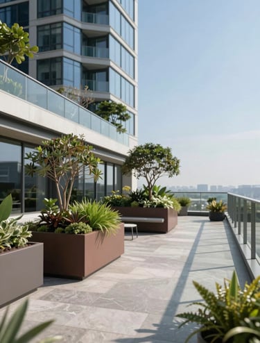 A close-up architectural shot of a sustainable rooftop terrace on a modern skyscraper. It features sleek #6B6760 planters with architectural greenery, #D9D2C7 limestone flooring, and a glass glass railing reflecting a clear blue sky. Professional architectural photography style, clean and precise.