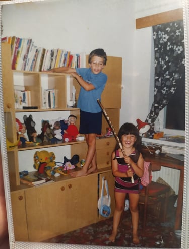 A young girl playing with a young boy