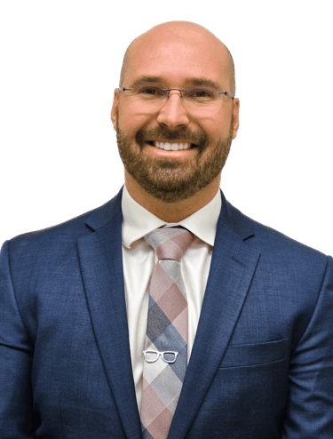 man wearing a suit and tie with glasses on