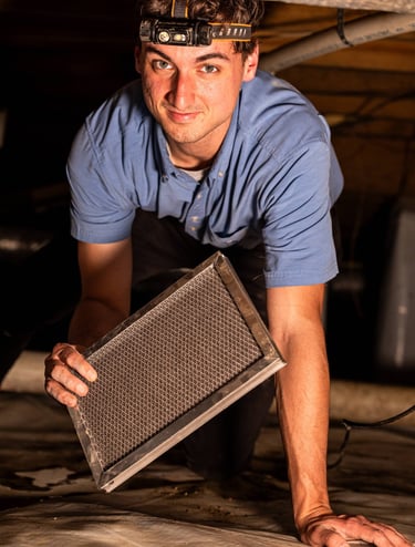 Jayden Kelley replacing a Dehumidifier Air Filter