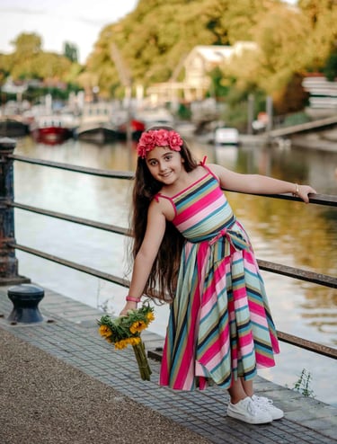 Girl holding flowers by riverside – Fred Art Studio kids photography