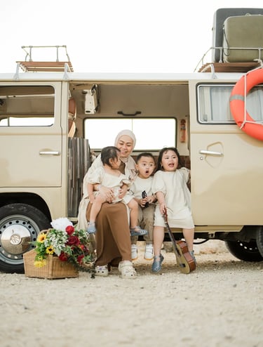Ilham family portrait beside a vintage retro combi van at Melasti Beach Bali