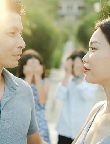 Couple sharing a romantic moment in a tropical garden during a luxury family photography session at The Ritz-Carlton Bali.
