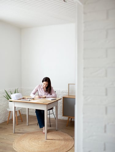 a woman sitting at a table with papers