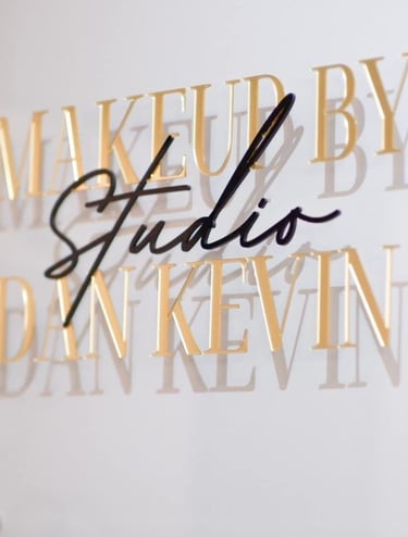 Acrylic Wall Frame with Gold and black text that say Makeup by studio Dan Kevin