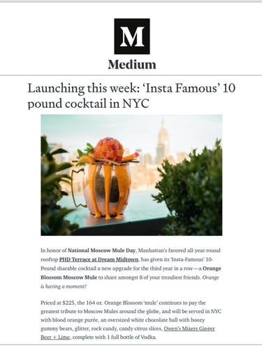 a cocktail in a glass vase with a cocktail glass