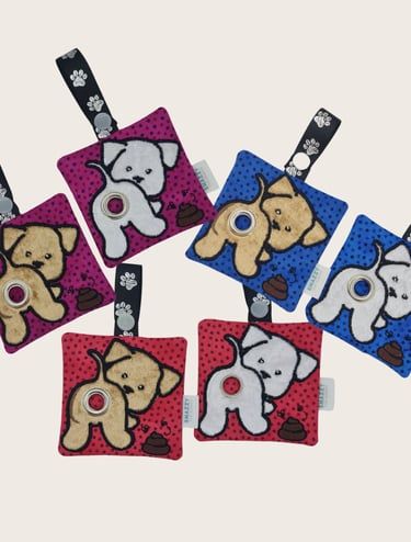 Colorful dog-themed keychains featuring plush designs, printed straps, and an embroidered poop bag holder