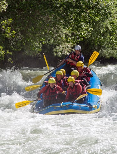 a group of people rafting down a river in switzerland