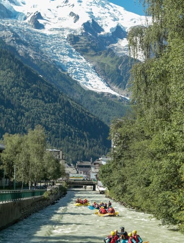 a group of people rafting down a river in chamonix