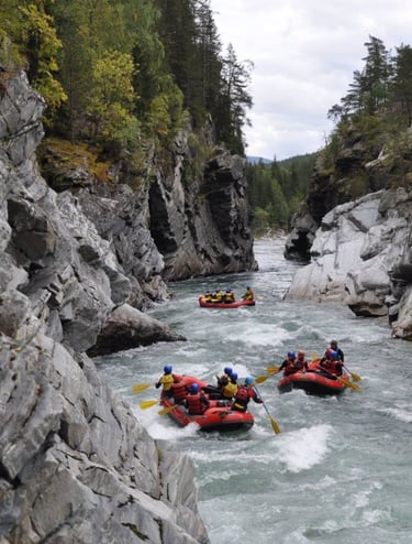a group of people rafting down a river in norway