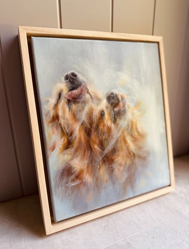 An original oil painting of golden retrievers, framed in a natural wood float frame 