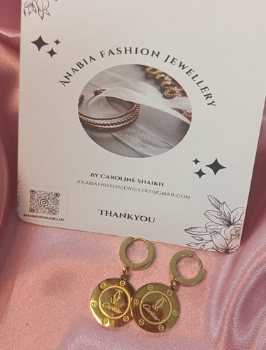 a pair of earrings with a gold ring and a pair of earrings