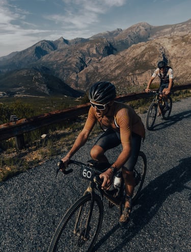 two men riding there bicycles in race- performance coaching