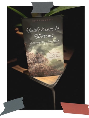 Battle Scars & Blossoms book on desk by Micah Dawanyi