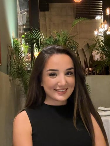 a woman sitting at a table with a plate of food