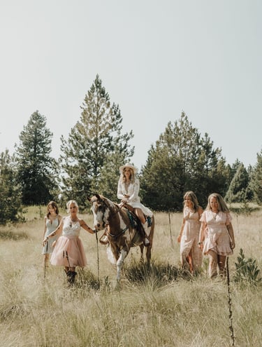 bridesmaid photos, bride riding paint horse, field, pine trees, Big Arm State Park