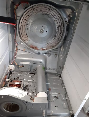 dryer taken a part and showing an exposed heating element