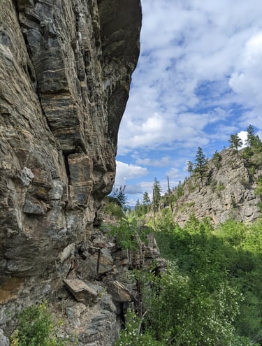 Rock face with a hill in the background