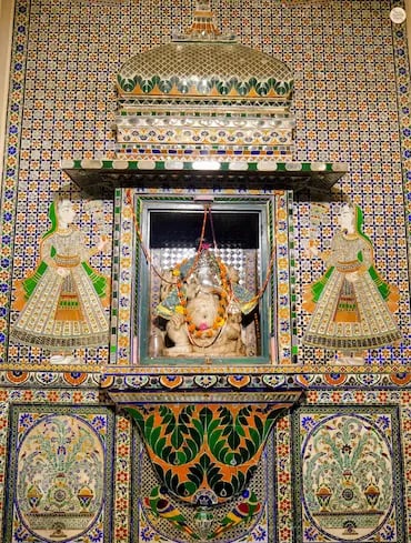Colorful glass and tile patterns inside Ganesh Deodi, Udaipur City Palace museum entry gate.