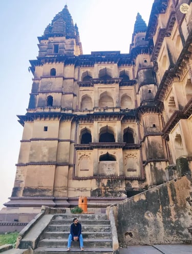 Sitting on the steps of Chaturbhuj Temple, Orchha - capturing its towering beauty.