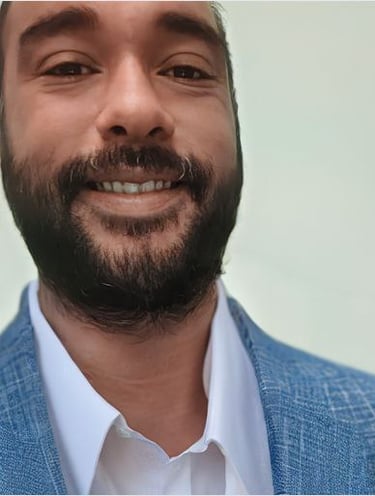 a man with a beard in a suit smilling