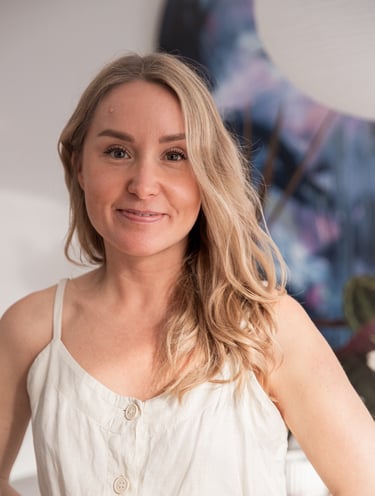 Saija Uussaari smiling in a white outfit