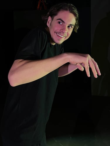a man in a black shirt is holding a skateboard